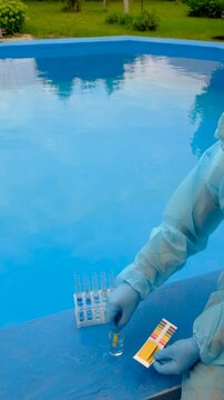 take a water sample from the pool. Selective focus.