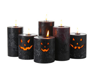 Halloween-themed lighted candles isolated on white background.