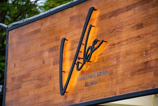 Close-up view of the Vibe Beach Club & Kitchen sign in Selce, Croatia. Local beach restaurant and travel destination.