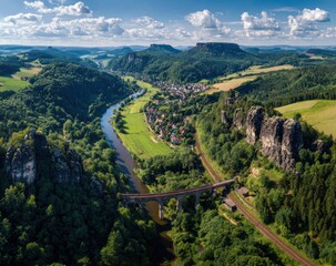 Panoramic view of a valley with a river, a village, and sandstone formations
