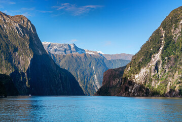 Tourist boat cruising through Milford Sound in South Island, New Zealand