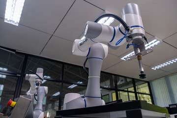 Robots engaged in precision assembly tasks inside a high-tech manufacturing facility during the daytime