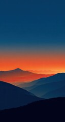 Misty mountain range at sunrise. Deep blues and oranges blend in a tranquil scene