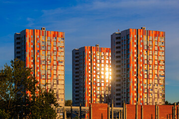 Cityscape on a sunny evening, modern buildings and houses 