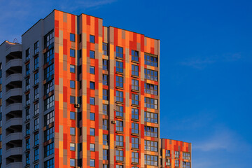 Modern buildings, walls and windows, reflections and sun rays. City view on a sunny day. 