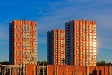 Cityscape on a sunny day, modern buildings and houses 
