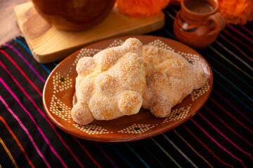 Pan de Muerto. Traditional Mexican sweet bread that is consumed in the season of the day of the dead. It is a main element in the altars and offerings in the festivity of Dia de Muertos in Mexico.
