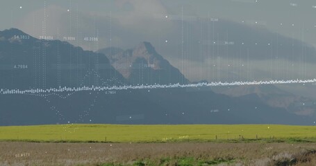 Fototapeta premium Projecting digital waveform overlay across rural farmland with mountain range, showing numeric data