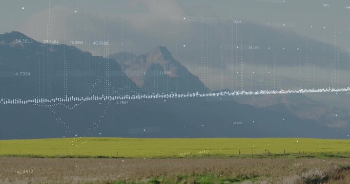 Fototapeta Projecting digital waveform overlay across rural farmland with mountain range, showing numeric data