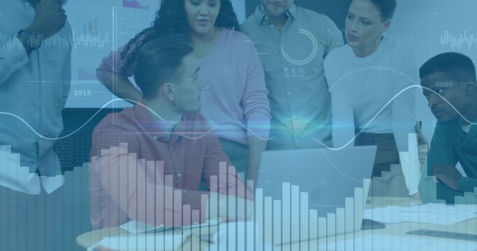 Collaborating team reviewing charts at conference room table, with laptop and digital overlays