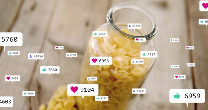 Featuring transparent jar of shell pasta on wood kitchen table, with floating notification icons - Powered by Adobe