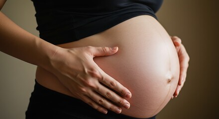 Close-up of a pregnant woman's hands gently cradling her round baby bump, Expectant mother tenderly holds her growing belly, symbolizing new life and maternal love.