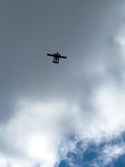 Airplane Flying Above Clouds in Blue Sky