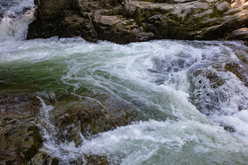 A picturesque rocky river with a waterfall.