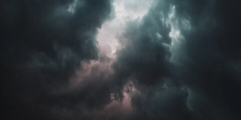 Obraz premium Dramatic and moody abstract clouds with a bright light breaking through the dark stormy sky