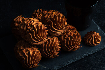 Coffee zephyr dessert arranged artistically on a dark slate surface, showcasing intricate textures...