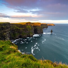 Dramatic cliffs meet the sea at sunset