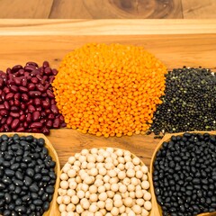 Various dried beans and lentils on wooden tray