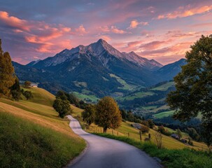 Winding road through a valley at sunset