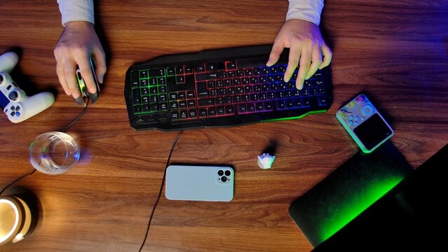 Colorful Gaming Setup with Keyboard and Accessories on Wooden Desk