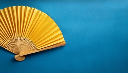 yellow paper fan on a blue background
