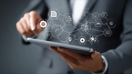 Professional interacts with digital tablet displaying innovative technology icons in a modern business environment - Powered by Adobe
