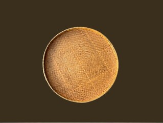 The brown background in the picture is a brown tray or winnowing basket woven from bamboo decorated with beautiful patterns. It is strong and sturdy. It is a circular tray used to hold various things.