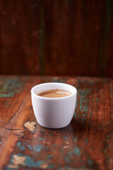 Cup of coffee on rustic wooden background. Soft focus. Copy space	