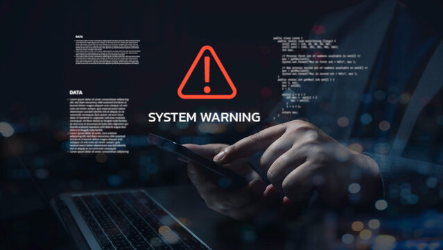 Programmer receiving system warnings on smartphone and laptop, with holographic code and data overlay, working late in a dark office with city lights bokeh