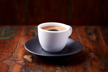 Cup of coffee on rustic wooden background. Soft focus. Copy space	