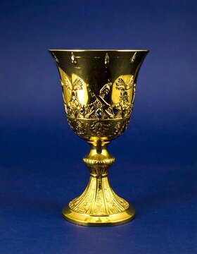 Ornate gold chalice against deep blue