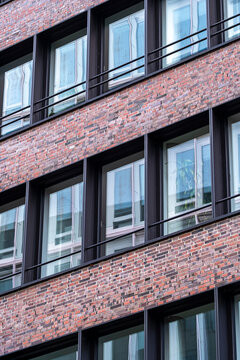 Close up of brick facade with rectangular windows in Hamburg, symbolizing corporate identity, urban design, real estate development and architectural clarity