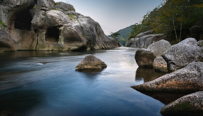 In Ethereal Dance Betwixt Rocks And Water Ceaseless Motion Of Aqueous Element Sculpts And Refines Countenance Of Stony Visage