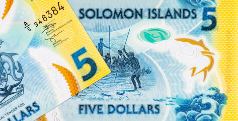 5 Dollars Solomon Islands. Polymer banknote with the image of a man fishing underwater. Money of...