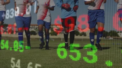 Five soccer players jogging on pitch, causing finance grid fading and showing live stock values - Powered by Adobe