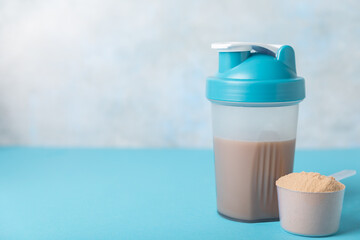 Obraz premium Protein powder. protein shake. Shaker bottle with protein. Food supplement. Whey protein powder with shaker for mixing. Sports nutrition. Concept of sports and healthy lifestyle. Sports equipment
