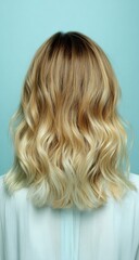 Naklejka premium Woman's back view, blonde wavy hair