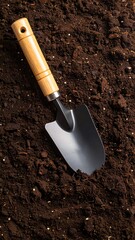 Gardening tool in dark soil