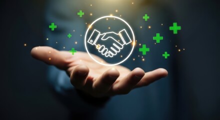 Hand holding a glowing handshake icon symbolizing partnership and growth