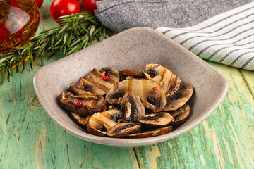 Tasty hot grilled champignon mushrooms