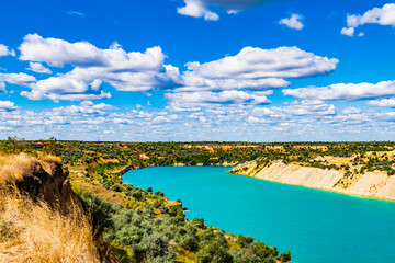 Lake with sandy shore in the abandoned coal quarry