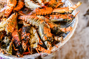 Prepared spiny lobsters on a plate. Exotic seafood