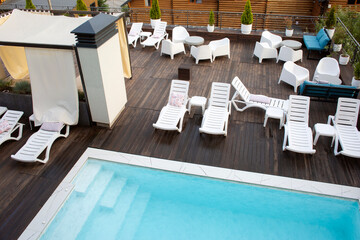 Recreation complex with sun loungers and a swimming pool.