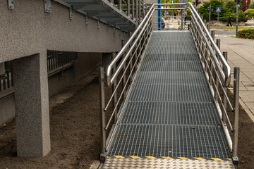 Obraz premium Accessible ramp for disabled people, metal ramp with handrails for strollers and disabled people,