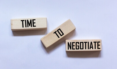 time to negotiate text on cubes on wooden background