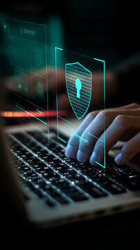 Person typing on laptop with digital security shield overlay cybersecurity data protection