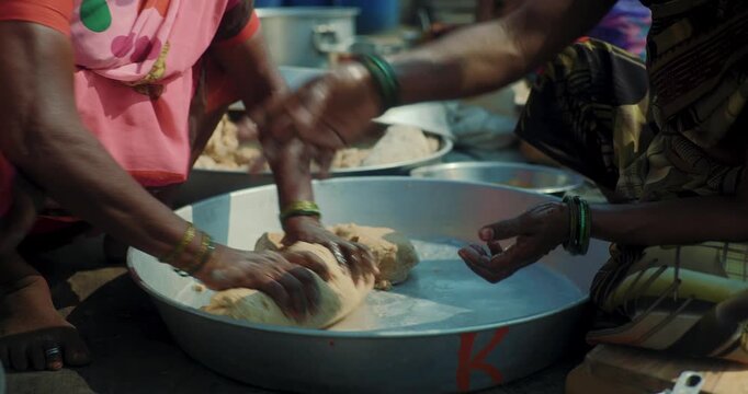 Traditional Indian Community Preparing Giant Sacred Flatbreads for Spiritual Festival &ndash; Kneading Dough, Roasting, and Cutting Large Roti During Ritual Celebration