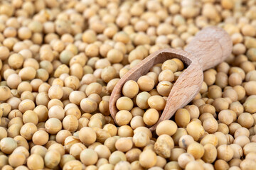 Raw dehydrated soybeans texture background top view.