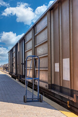 Fototapeta premium railway porter, two wheel trolley cart, dollies, wagon transport on the railway, cart transporting goods