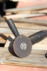 Angle grinders, power tools for construction and repair work. Tool for cutting and grinding hard materials. Old angle grinder with cord. Repair work in the country. Grinder with a metal disc